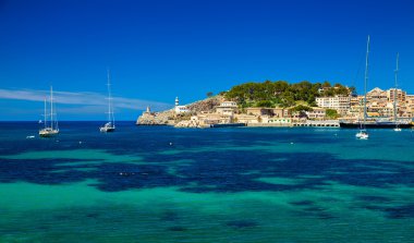 beautiful harbour with lighthouse and yachts clipart