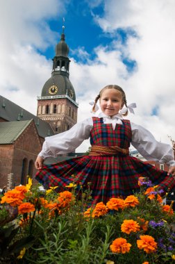 Latvian girl near the Cathedral clipart