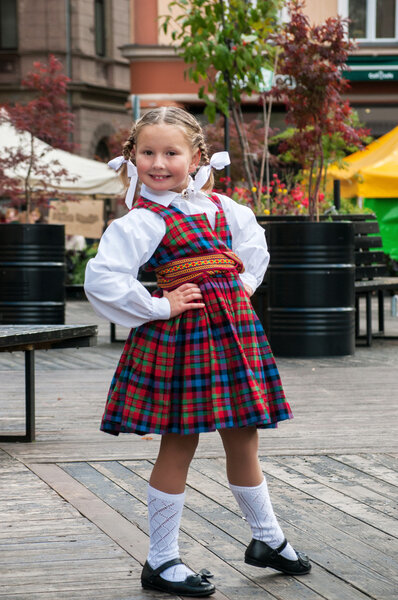 The dancing girl in latvian traditional suit