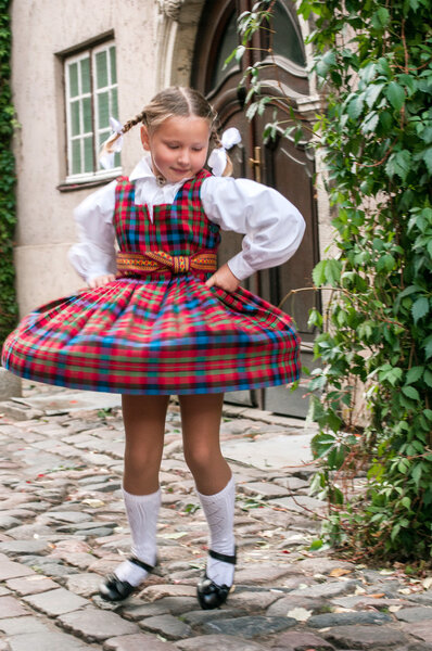 The dancing girl in latvian traditional suit