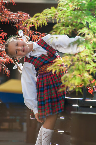 Portrait of cute girl in latvian national suit