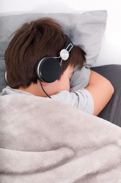 Portrait of a beautiful sleeping teenager in earphone — Stock Photo, Image