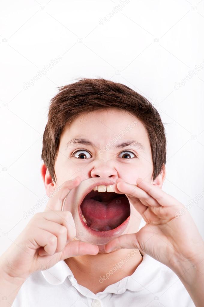 Boy holding a magnifying glass to his mouth