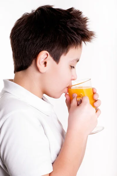 Boy drinks orange juice — Stock Photo, Image