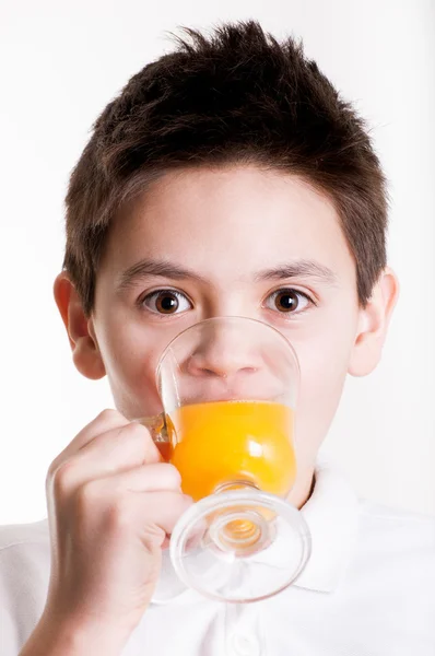 Boy drinks orange juice — Stock Photo, Image