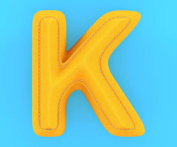 Leather yellow texture letter K — Stock Photo, Image