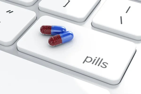 Pills on the computer laptop keyboard Royalty Free Stock Photos