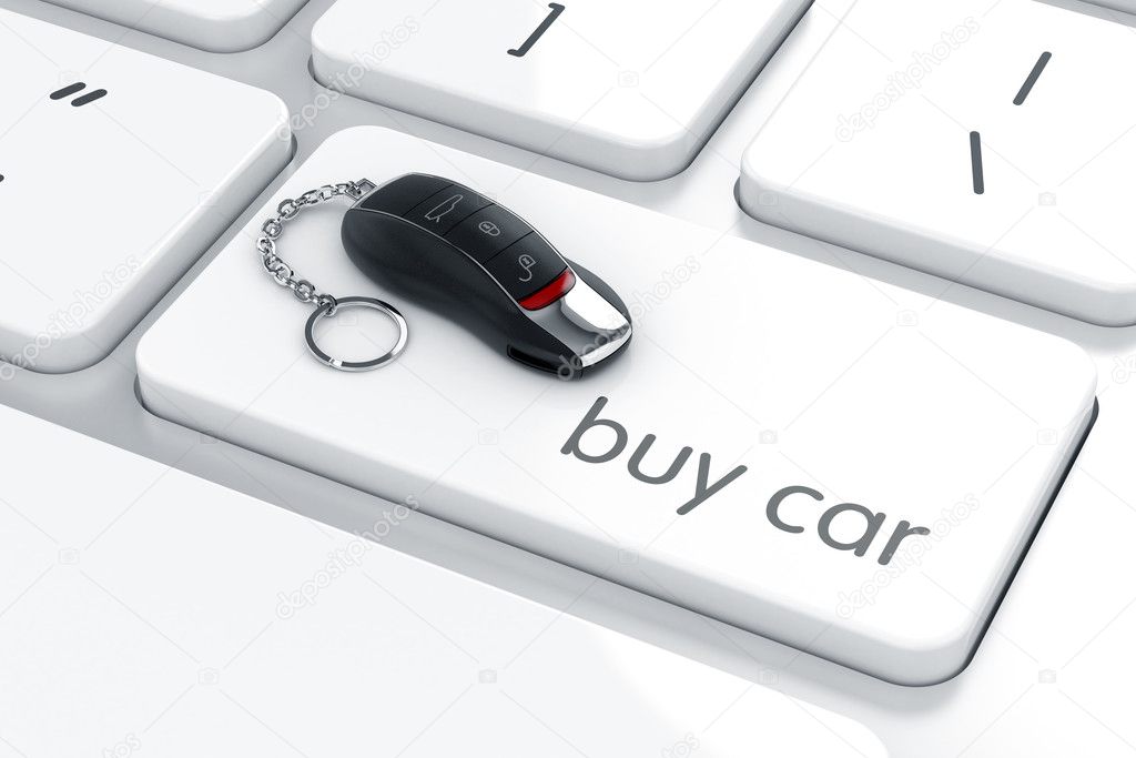 Luxury car key with remote control on the computer keyboard. Car
