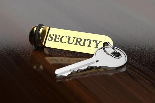 Room key with golden keychain security concept — Stock Photo, Image
