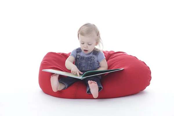 Toddler girl reading Royalty Free Stock Photos