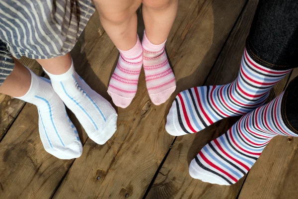 Child legs in colorful striped socks