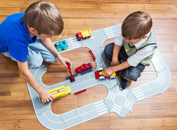 Two little boys plays with toy car — Stock Photo, Image