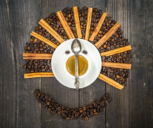 Smiling face made from cup of fresh coffee and beans — Stock Photo, Image