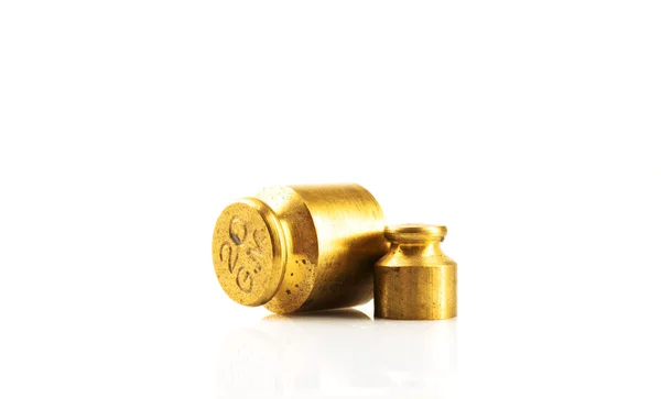 Old style gold color weight on a white background. — Stock Photo, Image