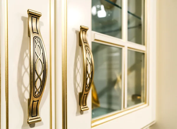 Metal ornate handle on a wooden cupboard — Stock Photo, Image