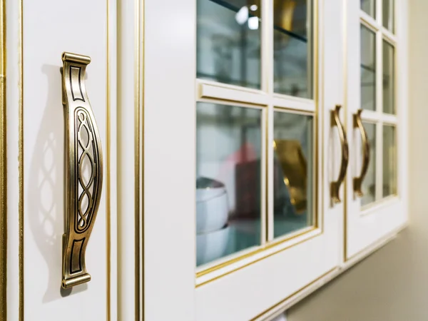 Metal ornate handle on a wooden cupboard — Stock Photo, Image