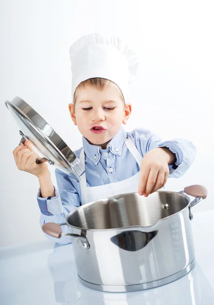 Kleiner Junge, gekleidet wie ein Koch beim Abendessen — Stockfoto