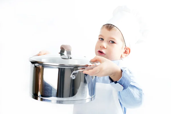 Kleiner Junge, gekleidet wie ein Koch beim Abendessen — Stockfoto