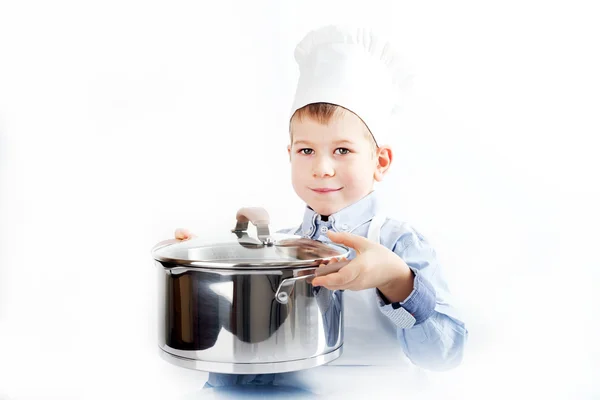 Kleiner Junge, gekleidet wie ein Koch beim Abendessen — Stockfoto