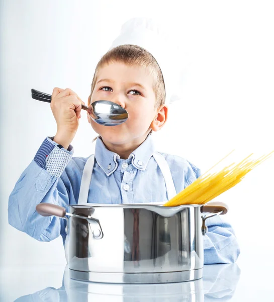 Kleiner Junge, gekleidet wie ein Koch beim Abendessen — Stockfoto