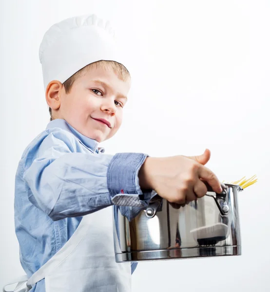 Kleiner Junge, gekleidet wie ein Koch beim Abendessen — Stockfoto