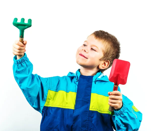 Happy spring gardening boy with seedlings and tools on white background. — Stock Photo, Image