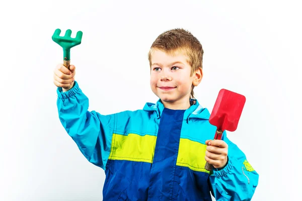 Happy spring gardening boy with shovel and rake — Stock Photo, Image