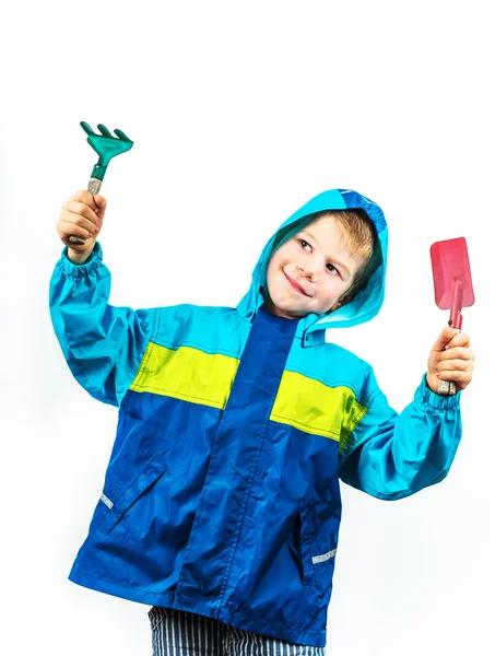 Happy spring gardening boy with shovel and rake — Stock Photo, Image