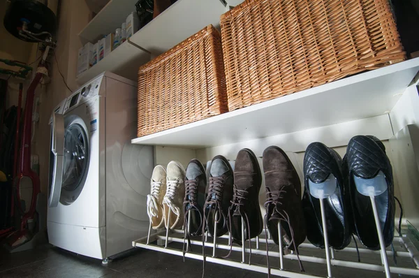 Some pairs of men's shoes on SHOE RACK in the storeroom at home