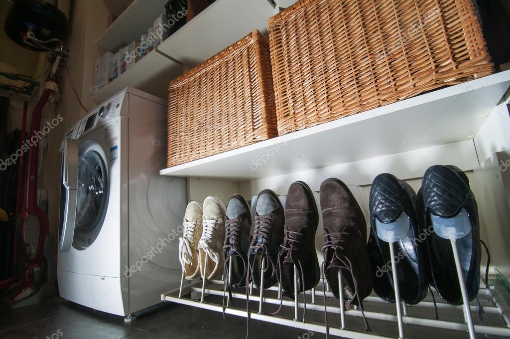 Some pairs of men's shoes on SHOE RACK in the storeroom at home
