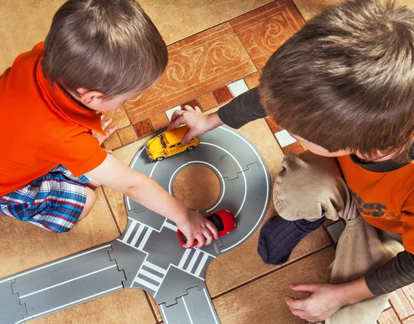 Two little boys plays with toy car — Stock Photo, Image