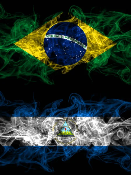 Brazil, Brazilian vs Nicaragua, Nicaraguan smoky mystic flags placed side by side. Thick colored silky abstract smoke flags.