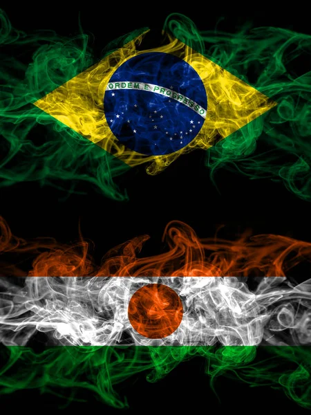 Brazil, Brazilian vs Niger, Nigerien smoky mystic flags placed side by side. Thick colored silky abstract smoke flags.