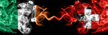 Republic of Ireland, Irish vs Switzerland, Swiss smoky mystic flags placed side by side. Thick colored silky abstract smoke flags.