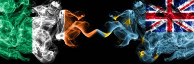 Republic of Ireland, Irish vs Tuvalu smoky mystic flags placed side by side. Thick colored silky abstract smoke flags.