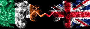 Republic of Ireland, Irish vs United Kingdom, Great Britain, British smoky mystic flags placed side by side. Thick colored silky abstract smoke flags.
