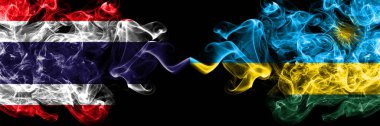 Tayland, Tayland vs. Ruanda 'nın dumanlı mistik bayrakları yan yana. Kalın renkli ipeksi soyut sigara bayrakları.