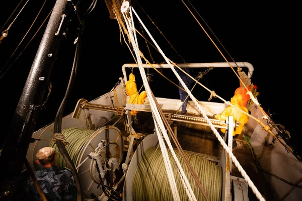 Fishermen standing at the stern of small fishing vessel — Stock Photo, Image