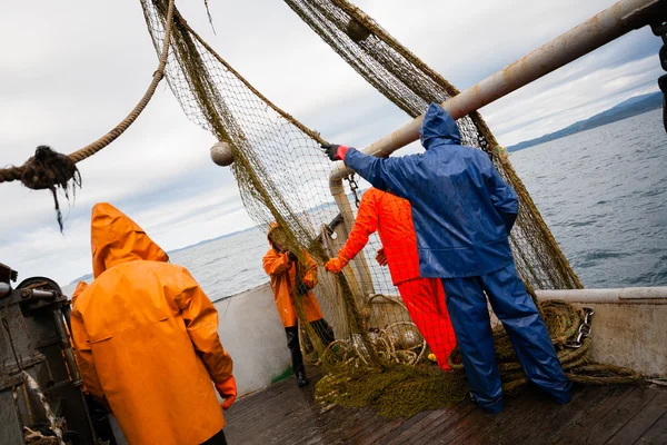 Fishermen in protective suits on deck Fishing vessel — Stock Photo, Image