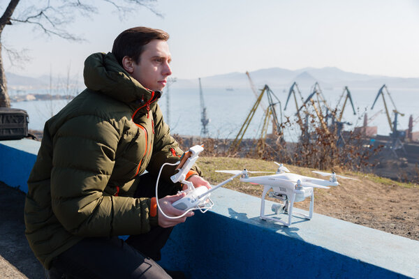 Man prepares a drone to a controlled flight