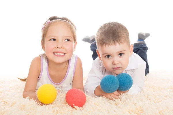 Asian girl and European boy playing with balls Stock Image