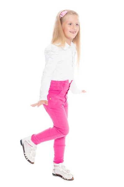 Speelse meisje in roze jeans. — Stockfoto