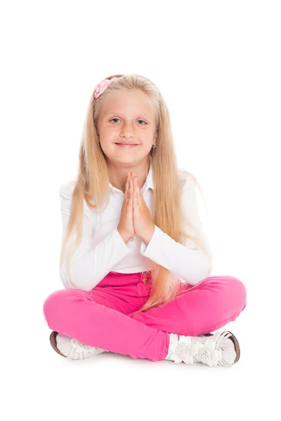 Little girl sitting in the lotus position. — Stock Photo, Image