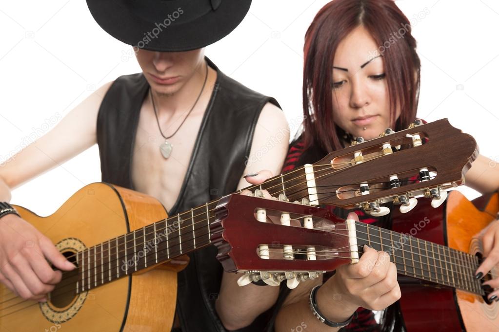 Young musicians play guitars