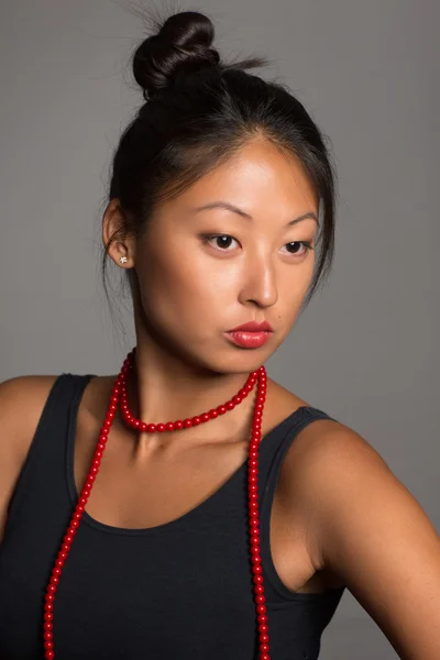 Asian  girl with red beads — Stock Photo, Image