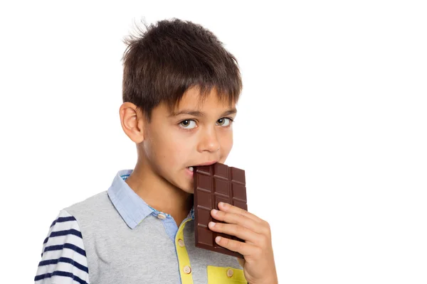 Portrait of boy eats chocolate — Stock Photo, Image