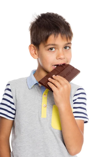 Little boy eats chocolate — Stock Photo, Image