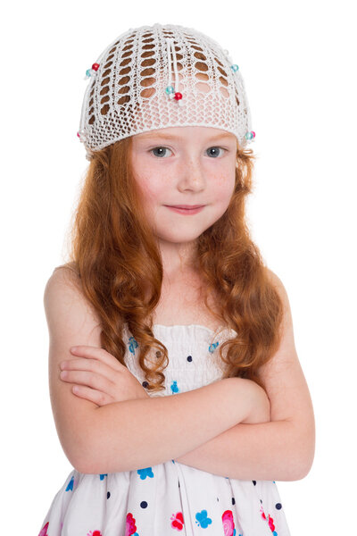 Red haired girl in a knitted cap