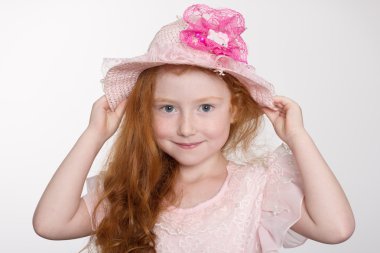 Llittle girl of six years in a hat 