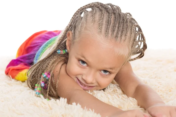 Cute little girl with dreadlocks lays — Stock Photo, Image